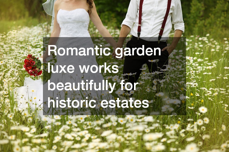 bride and groom holding hands in a bed of white flowers